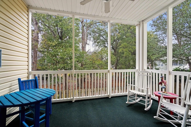 sunroom featuring a wealth of natural light, wooden ceiling, and ceiling fan