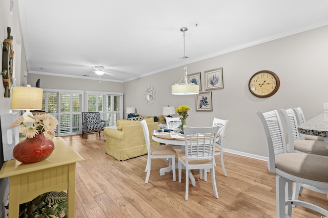 dining area featuring ornamental molding, ceiling fan, and light wood-type flooring