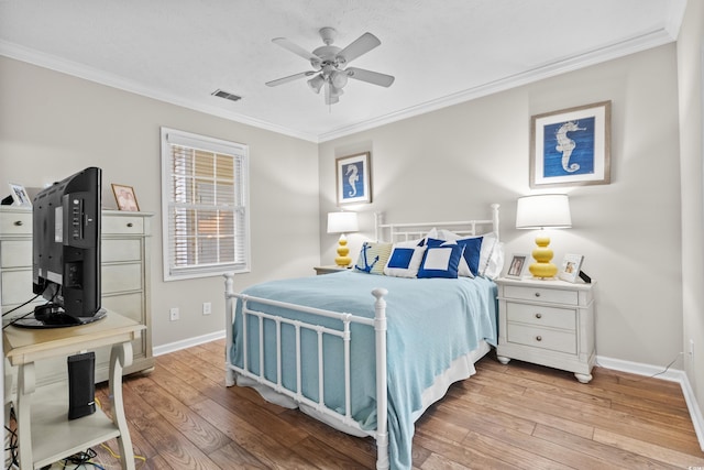 bedroom with crown molding, light hardwood / wood-style flooring, and ceiling fan