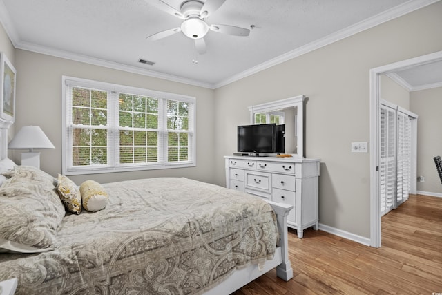 bedroom featuring ornamental molding, ceiling fan, and light wood-type flooring