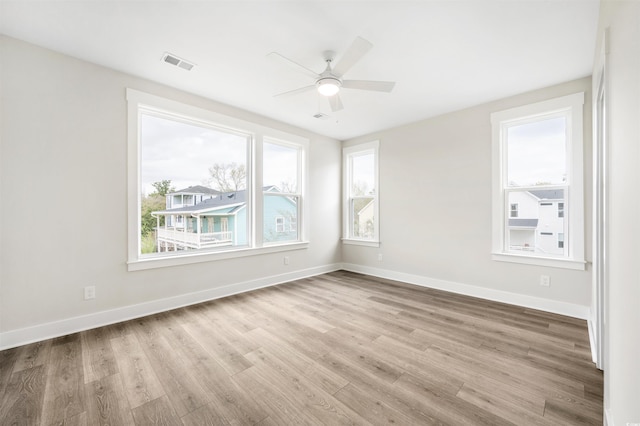 unfurnished room with ceiling fan and light wood-type flooring