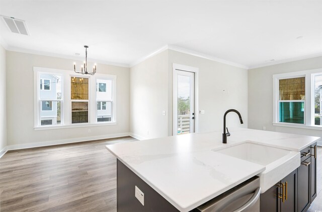 kitchen featuring stainless steel range with gas stovetop, light stone countertops, backsplash, sink, and white cabinetry