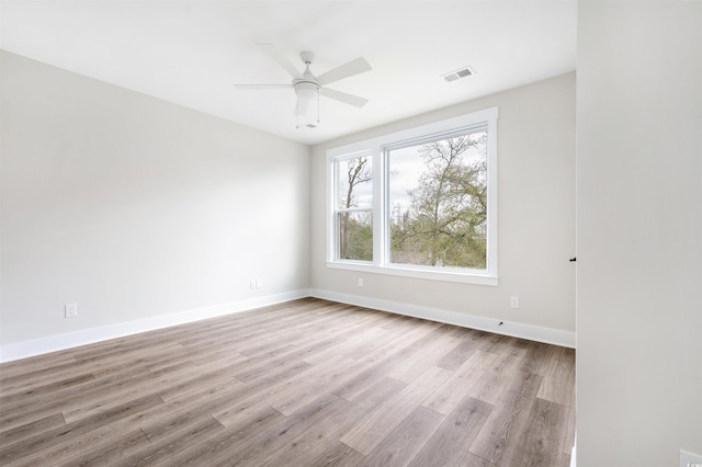 empty room featuring ceiling fan and light hardwood / wood-style floors