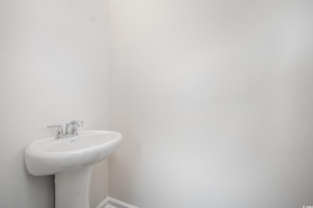 bathroom with baseboards and a sink