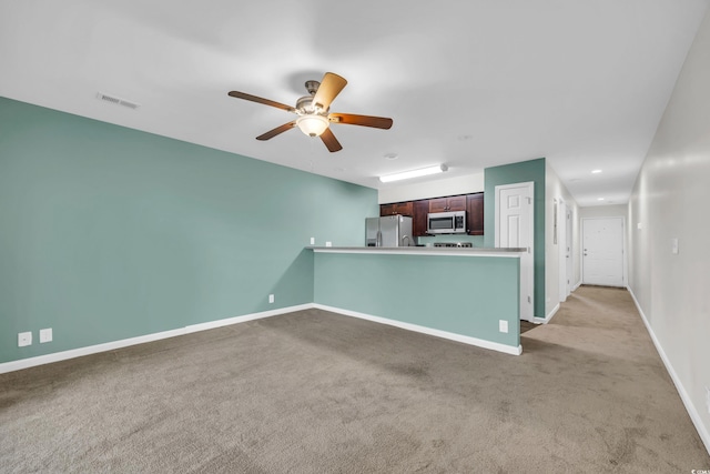 unfurnished living room with light carpet, baseboards, visible vents, and a ceiling fan