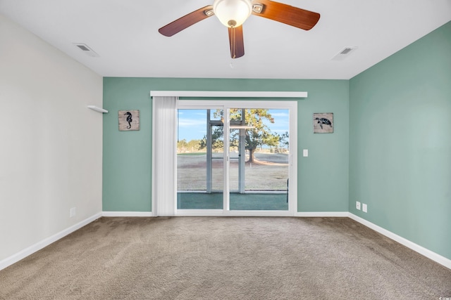 unfurnished room featuring carpet, visible vents, and baseboards