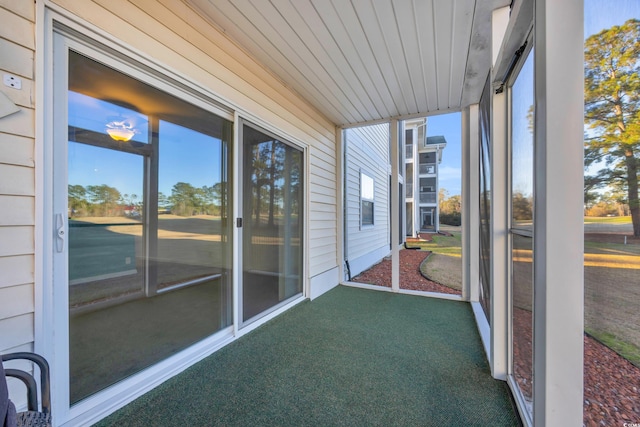 unfurnished sunroom with wood ceiling