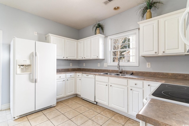 kitchen featuring white cabinetry, white appliances, sink, and light tile patterned floors