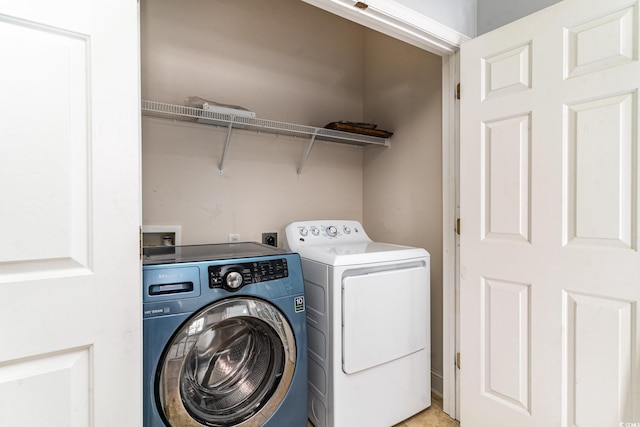 clothes washing area featuring separate washer and dryer