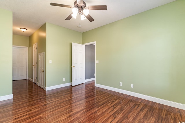 empty room featuring dark wood-type flooring and ceiling fan