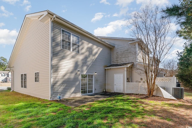 back of house featuring a patio and a lawn