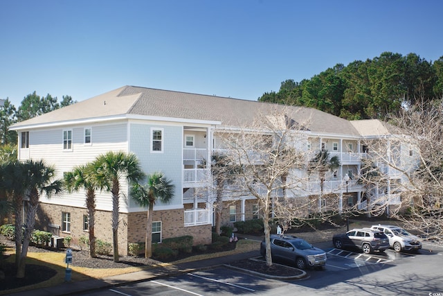 view of building exterior featuring uncovered parking