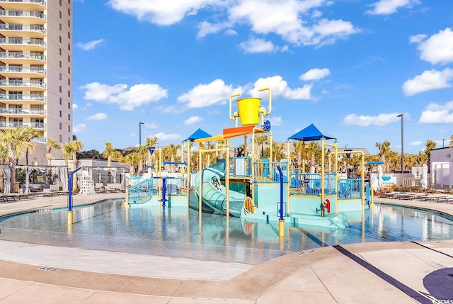 view of pool with a playground