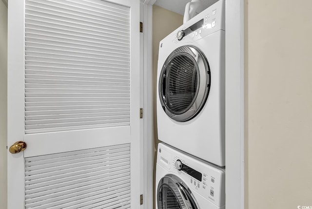 washroom with stacked washer and clothes dryer