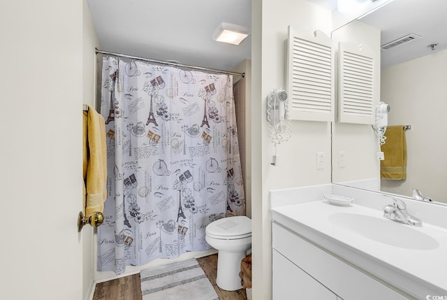 bathroom featuring vanity, toilet, hardwood / wood-style floors, and walk in shower