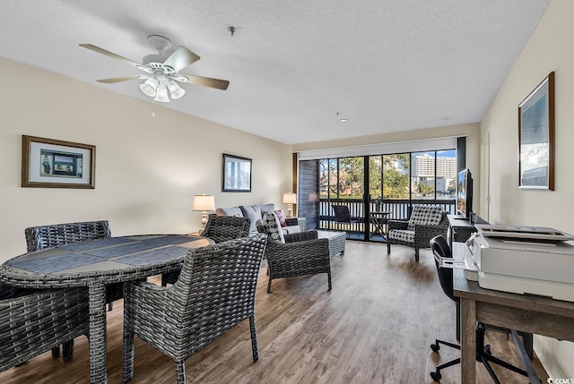 interior space featuring hardwood / wood-style flooring, ceiling fan, and a textured ceiling