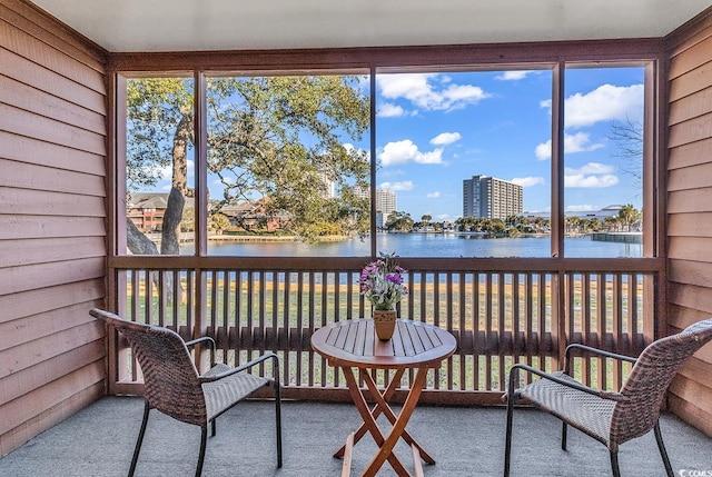 sunroom with a water view and plenty of natural light