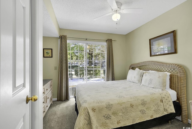 carpeted bedroom with ceiling fan and a textured ceiling