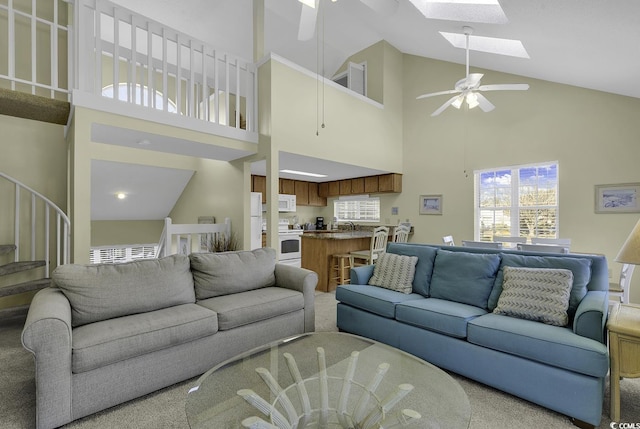 living room featuring a skylight and ceiling fan