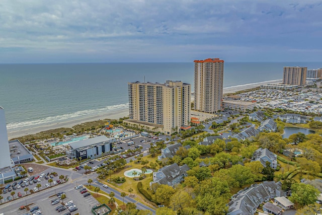 drone / aerial view featuring a water view and a beach view