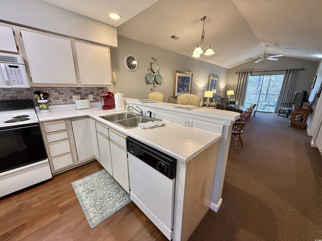 kitchen featuring sink, white cabinetry, decorative light fixtures, kitchen peninsula, and white appliances