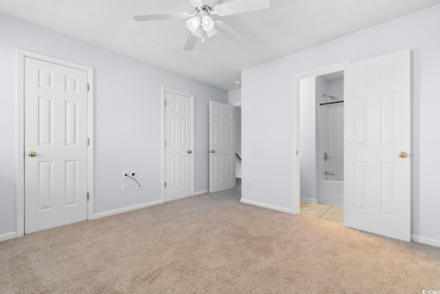 unfurnished bedroom with ceiling fan, light colored carpet, and connected bathroom