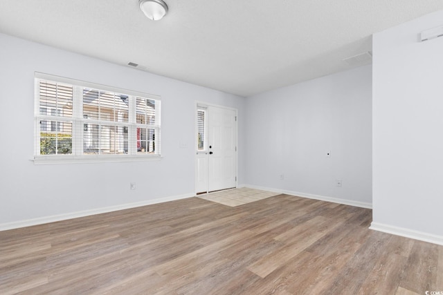 unfurnished room with light hardwood / wood-style floors