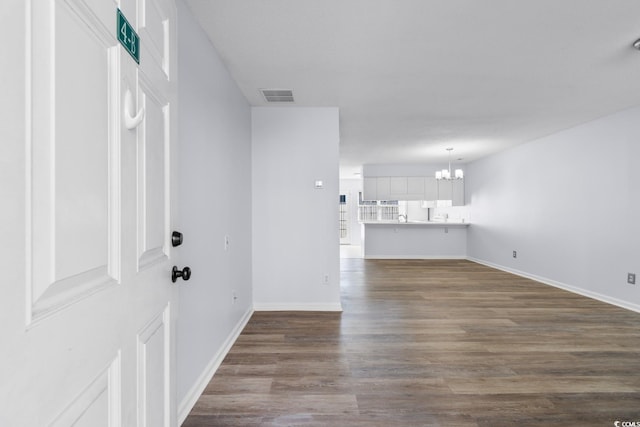 interior space featuring hardwood / wood-style flooring and a notable chandelier