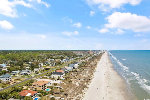 birds eye view of property featuring a water view and a beach view