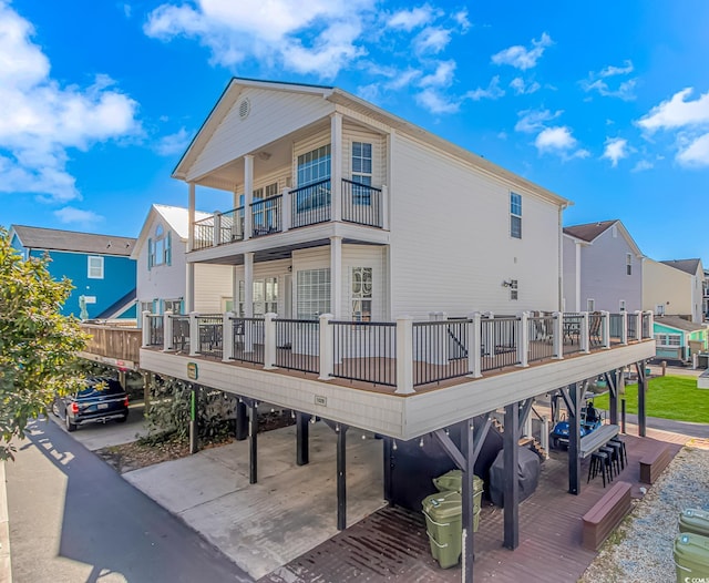 rear view of house with a balcony and a carport