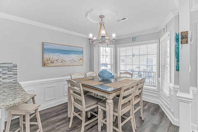 dining space with crown molding, dark wood-type flooring, and a chandelier