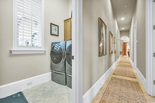 interior space with light tile patterned floors and washing machine and dryer