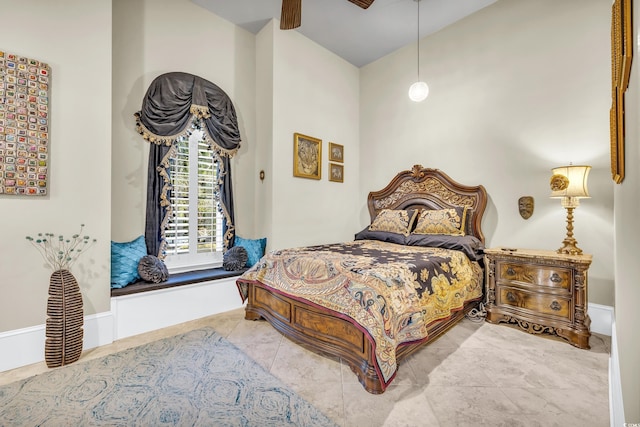 tiled bedroom featuring ceiling fan