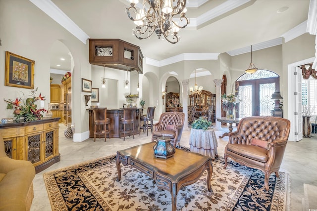 living room with crown molding, a notable chandelier, and french doors