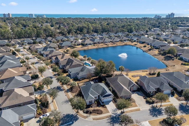 birds eye view of property with a water view and a residential view
