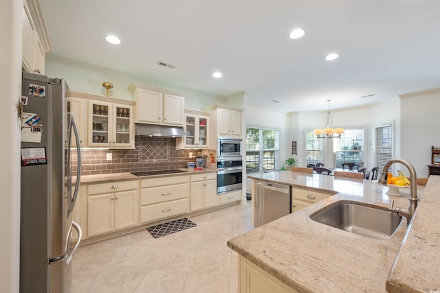 kitchen with visible vents, a notable chandelier, a sink, appliances with stainless steel finishes, and under cabinet range hood