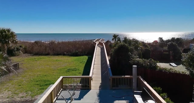 view of home's community featuring a yard and a water view