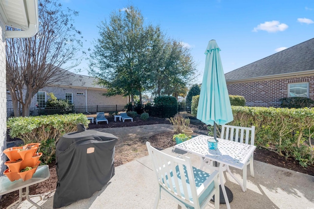 view of patio / terrace with grilling area, fence, and outdoor dining area