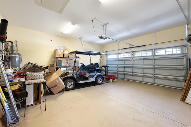 garage featuring a garage door opener and secured water heater
