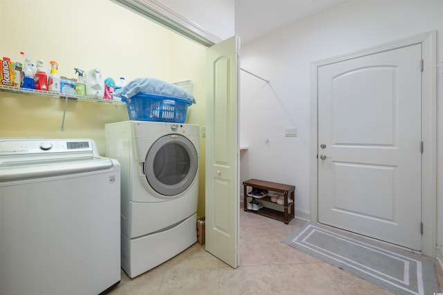 laundry room with laundry area, light tile patterned floors, and washing machine and dryer