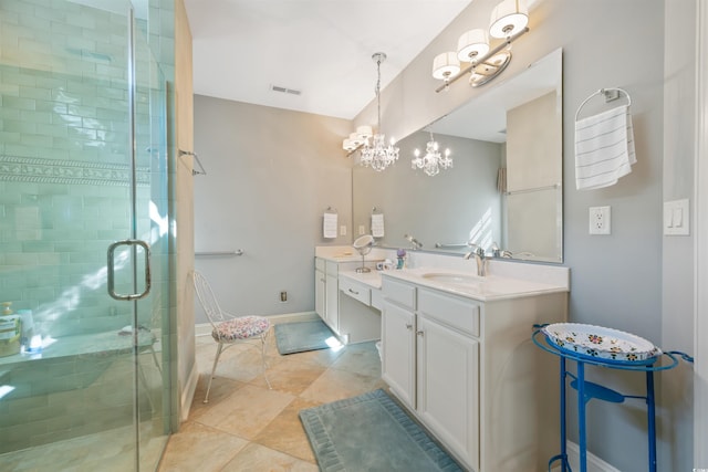 bathroom with double vanity, a stall shower, a chandelier, visible vents, and a sink