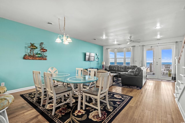 2022 N Waccamaw Dr, Garden City Beach, SC 29576 - dining space featuring wood finished floors, a ceiling fan, a chandelier, and baseboards