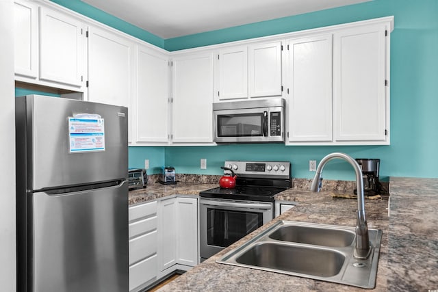 2022 N Waccamaw Dr, Garden City Beach, SC 29576 - kitchen with stainless steel appliances, a sink, and white cabinets