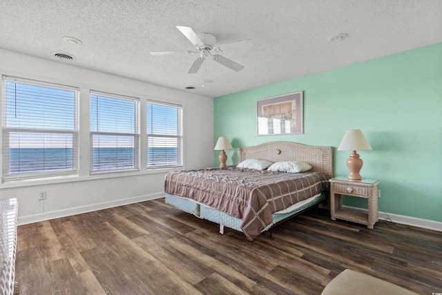 2022 N Waccamaw Dr, Garden City Beach, SC 29576 - bedroom featuring wood finished floors, a textured ceiling, baseboards, and a ceiling fan