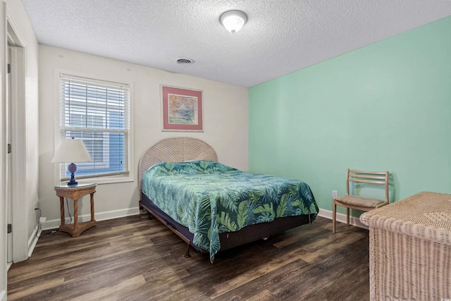2022 N Waccamaw Dr, Garden City Beach, SC 29576 - bedroom with wood finished floors, a textured ceiling, and baseboards