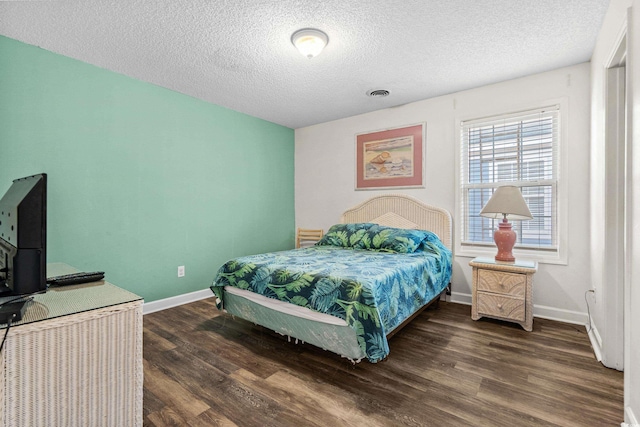 2022 N Waccamaw Dr, Garden City Beach, SC 29576 - bedroom featuring wood finished floors, baseboards, and a textured ceiling
