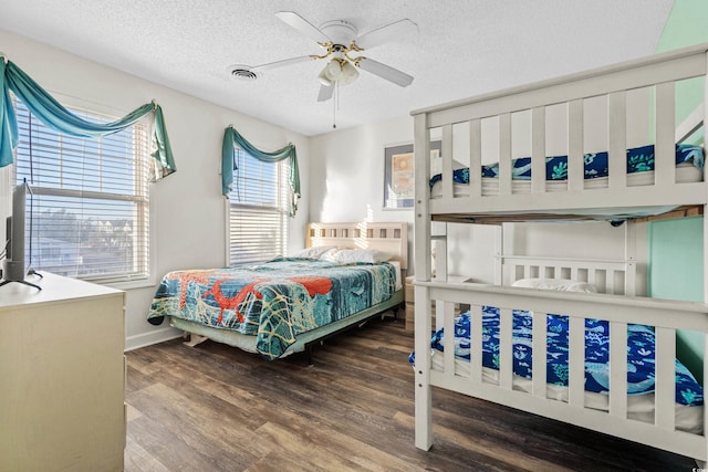 2022 N Waccamaw Dr, Garden City Beach, SC 29576 - bedroom featuring a textured ceiling, wood finished floors, ceiling fan, and baseboards