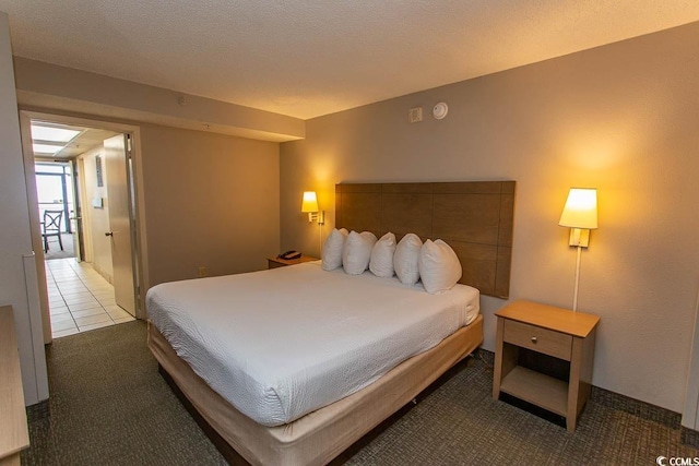 tiled bedroom with a textured ceiling