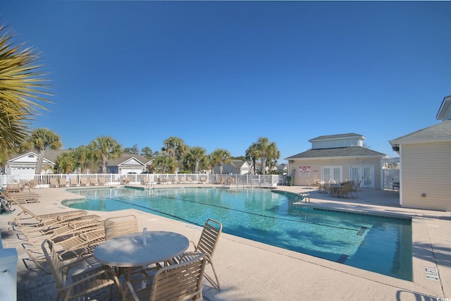 pool featuring fence and a patio