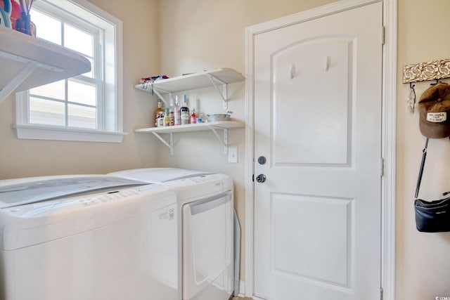 clothes washing area featuring washing machine and dryer and laundry area